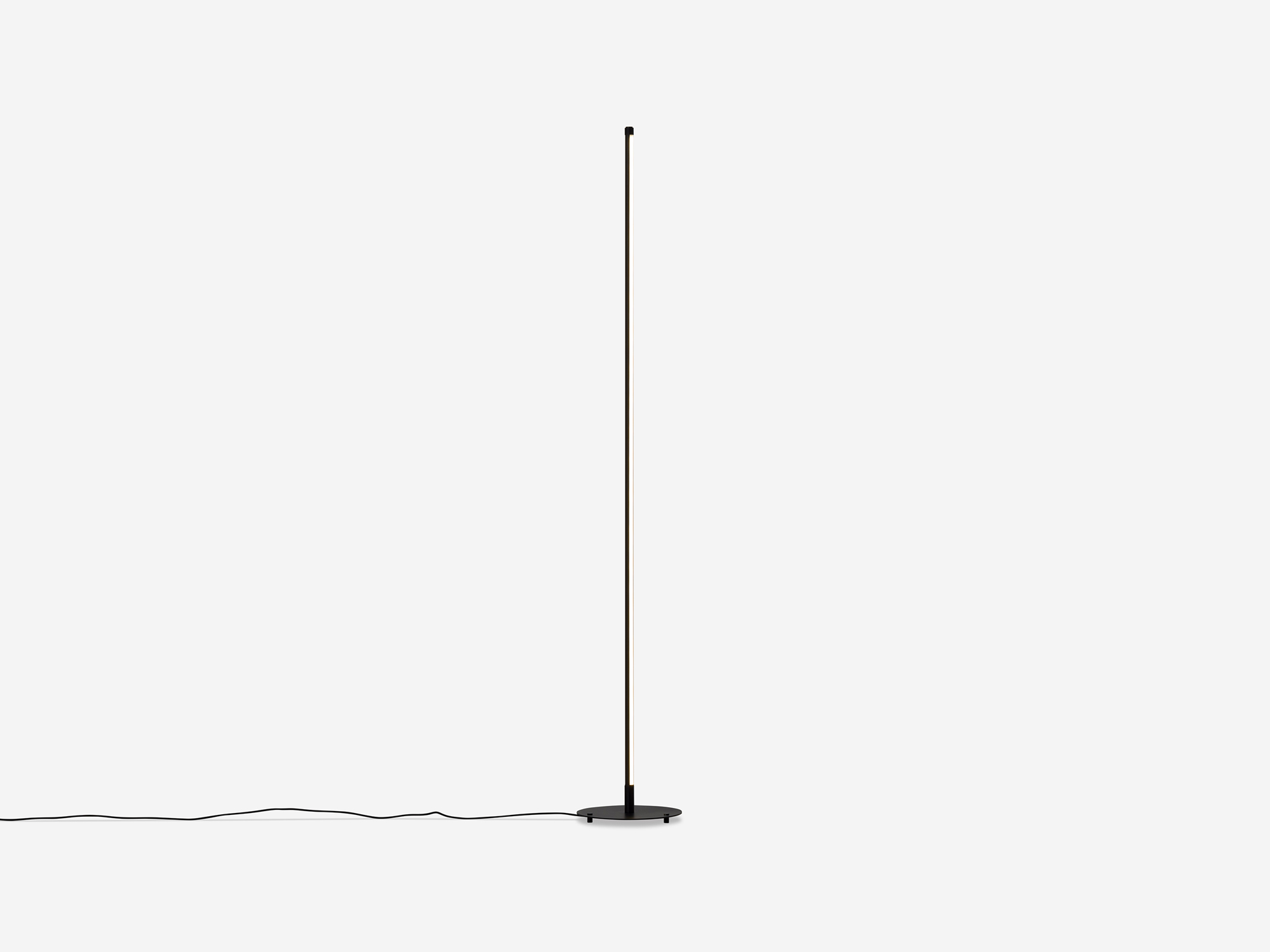 Front view of thin black floor lamp
